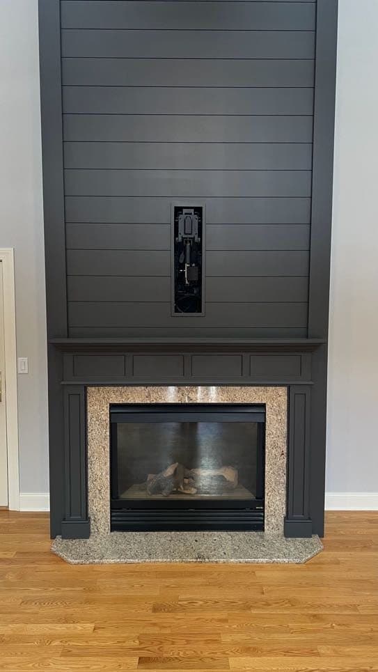 Recessed motorized TV mount in a dark shiplap wall, before the TV is installed